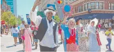  ?? | BRIAN JACKSON/ FOR THE SUN- TIMES FILE ?? State Sen. Kwame Raoul and state Rep. Barbara Flynn Currie march in the Hyde Park July 4th parade in 2014.