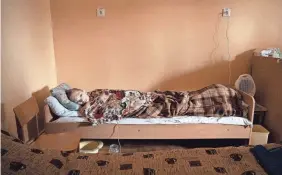  ?? PHOTOS BY MICHAEL G. SEAMANS/FOR USA TODAY ?? Bagdan, 13, lies in a bed in the basement of the Chernihiv, Ukraine. His father died in the explosion that wounded the child, but he was not aware of the news at the time.