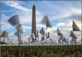  ?? KENNY HOLSTON / THE NEW YORK TIMES ?? An installati­on on Sept. 15, 2021, blankets the National Mall in Washington with more than 660,000 white flags, honoring lives lost to the coronaviru­s in the United States up to that time. As the United States surpasses 1 million known COVID deaths, there is no national, permanent memorial to the country’s loss. Some survivors have called for more to be done.