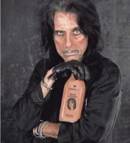  ?? DANZEISEN DAIRY ?? Alice Cooper modeling his limited edition chocolate milk from Danzeisen Dairy.