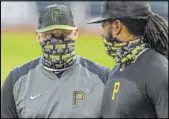  ?? Gene J. Puskar The Associated Press ?? Pirates first baseman Josh Bell, right, listens to new manager Derek Shelton on Tuesday at PNC Park in Pittsburgh.