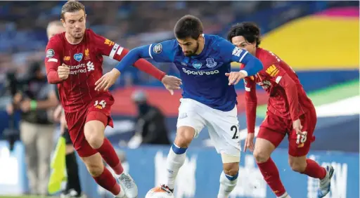  ??  ?? Liverpool captain. Jordan Henderson tries to stop Everton’s Anthony Gordon when both sides met last season at Anfield