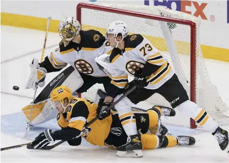  ?? Ap ?? BIG NIGHT: Bruins goaltender Daniel Vladar clears away a shot as Charlie McAvoy knocks down Pittsburgh’s Jake Guentzel during the first period on Tuesday in Pittsburgh.