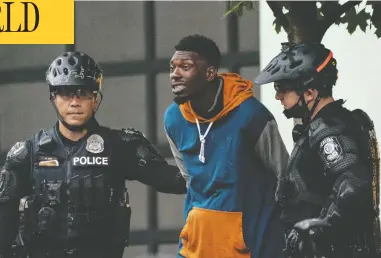  ?? DAVID RYDER / GETTY IMAGES ?? Police detain a man as crews clear the Capitol Hill Organized Protest area outside of the Seattle Police Department’s
vacated east precinct on July 1. “The CHOP has become lawless and brutal,” said Seattle Police Chief Carmen Best.