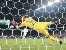  ?? Reuters; AP ?? Italy’s Gianluigi Donnarumma saves a penalty from England’s Jadon Sancho during the penalty shootout, while, right, the Azzurri celebrate after the match