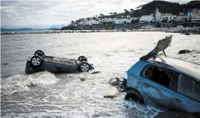  ?? — reuters ?? Aftermath: damaged cars are seen in the sea, following a landslide on the Italian holiday island of Ischia, Italy.