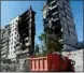  ?? AP/PTI ?? Donetsk People Republic Emergency Situations Ministry employees clear rubble at the side of damaged