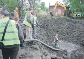  ?? ?? Utility workers operate next to a crater in the courtyard of a hospital in Kharkiv yesterday. PHOTO: AFP