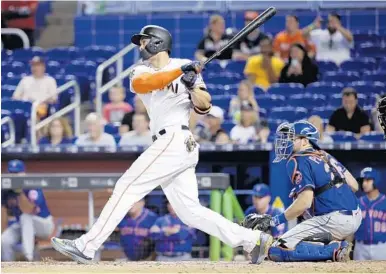  ?? LYNNE SLADKY/AP ?? Giancarlo Stanton hit his major league leading 56th home run, a two-run shot to left, off a curveball in the eighth inning Wednesday.
