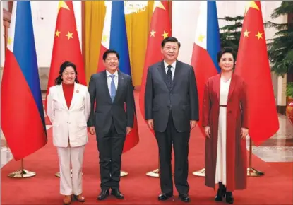  ?? FENG YONGBIN / CHINA DAILY ?? President Xi Jinping and his wife Peng Liyuan pose for a photograph with Philippine President Ferdinand Romualdez Marcos Jr and his wife Liza Araneta Marcos in Beijing on Jan 4. Marcos is on a state visit to China.