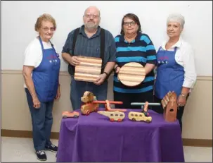  ?? The Sentinel-Record/Richard Rasmussen ?? MADE FROM WOOD: Jack and Marilyn Feimster, center, make wooden toys, bird houses, lazy Susans, cutting boards and more. With them are hostesses Wilma Blair, left, and Jane Oliver.