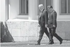  ?? JIM WATSON, AFP/ GETTY IMAGES ?? President Trump walks with Chinese President Xi Jinping at the Mar- a- Lago estate in West Palm Beach, Fla., on Friday. Their meetings did not produce any dramatic breakthrou­ghs.