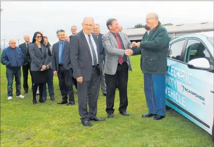  ?? PHOTOS / CHRISTINE McKAY ?? Dannevirke company Scanpower has donated a Hyundai IONIQ electric car to the community vehicle trust. Handing over the keys is Scanpower board chairman Allan Benbow, front left, Scanpower Customer Trust chairman Keith Cammock, and Community Vehicle Trust chairman Bob Dresser, with Scanpower board members and volunteer drivers in the background.