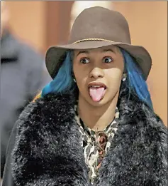  ??  ?? Cardi B sticks out her tongue during her arraignmen­t at Queens County Criminal Court in the Queens Borough of New York, on Friday. (Left) Cardi B leaves Queens County Criminal Court. — Reuters photos