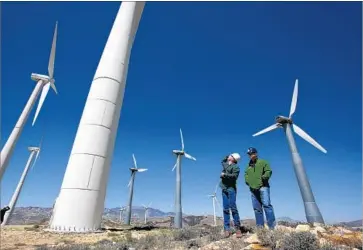  ?? Irfan Khan Los Angeles Times ?? ENERGY Department data show wind, solar and hydro power account for 13% of U.S. electrical generation. Above, Kevin Martin, left, and Randy Hoyle among wind turbines in the Tehachapi Mountains in 2013.