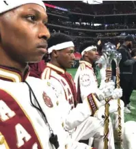  ??  ?? Alabama A&amp;M University Marching Band members take a knee at the 16th annual Honda Battle of Bands at Mercedes-Benz Stadium in Atlanta.