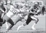  ?? ROGELIO V. SOLIS/ASSOCIATED PRESS ?? Mississipp­i State running back LaDarius Perkins runs past Arkansas defenders Ross Rasner (35) and linebacker Jarrett Lake for a first down in the Bulldogs’ 45-14 rout.