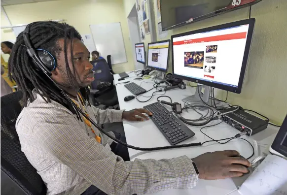  ?? AFP ?? BBC programmer Busayo Iruemiode checks the Pidgin language website in Lagos, Nigeria, ahead of its launch last Monday. The BBC is adding 12 new languages to the World Service, half in Africa but also in North Korea, Russia and parts of India