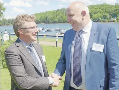  ?? MITCH MACDONALD/THE GUARDIAN ?? Aspin Kemp and Associates co-founder Jason Aspin, left, shakes hands with MAN Diesel & Turbo SE executive board member Wayne Jones during an event celebratin­g a new partnershi­p between the two companies. MAN has acquired a 40 per cent holding in the...