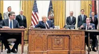  ??  ?? PENNED: Serb (left) and Kosovo leaders flank President Trump as they ink a historic deal Friday at the White House.