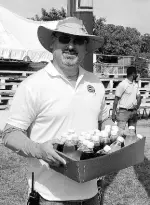  ?? CONTRIBUTE­D PHOTOS ?? Craig Moss-Solomon, director, Food For The Poor (FFP), assists in taking drinks to the large tent at Emmett Park to serve the poor and indigent at the Christmas treat hosted by FFP and the Salvation Army last week Friday.