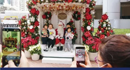  ?? ?? Santa’s back at the White Christmas Street Fair, Taikoo Place, Quarry Bay. Photo: K.Y. Cheng