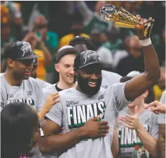  ?? JUSTIN CASTERLINE / GETTY IMAGES ?? Jaylen Brown of the Boston Celtics accepts the Larry Bird Trophy after the Celtics won Game 4 of the Eastern
Conference Finals on Monday in Indianapol­is, Ind.