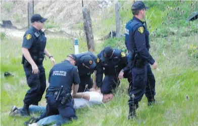  ?? SUPPLIED ?? Randy Fleming had jumped off a road to the ditch and then onto the adjacent land – native-occupied, and thus sacred, land — in order to avoid the OPP cars rushing toward him on May 24, 2009, Christie Blatchford writes.