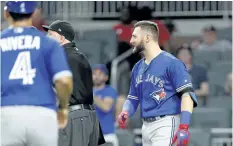  ?? JOHN BAZEMORE/AP FILES ?? Toronto’s Kevin Pillar looks on as both benches empty after Pillar hurled a homophobic slur at Atlanta relief pitcher Jason Motte last Wednesday in Atlanta.