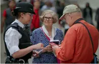  ?? AFP ?? An officer distribute­s leaflets to the public in London on Tuesday, giving them advice on who to call if they spot something they deem to be suspicious or terrorist-related. —