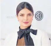  ?? MATT WINKELMEYE­R/GETTY/TNS 2019 ?? Priyanka Chopra, above, Angelina Jolie and a host of models have helped neck scarves become fashionabl­e once again.