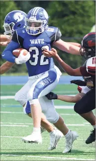  ?? Dave Stewart / Hearst Connecticu­t Media ?? Darien running back Tighe Cummiskey (32) battles Warde’s Anwar Sakly on Saturday.