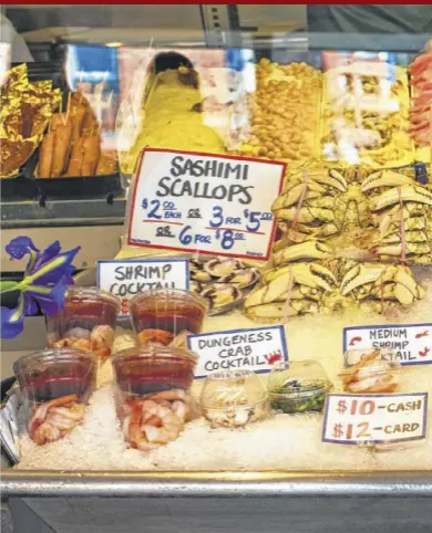  ??  ?? The Pike Place Market in Seattle features an array of seafood. You touch, you buy!