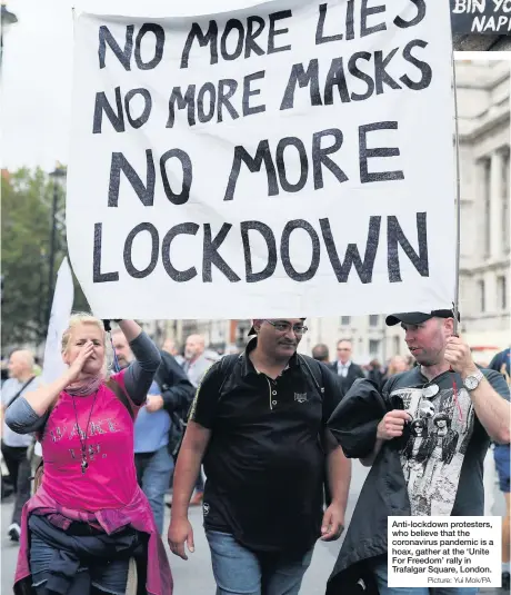  ?? Picture: Yui MOK/PA ?? Anti-lockdown protesters, who believe that the coronaviru­s pandemic is a hoax, gather at the ‘Unite For Freedom’ rally in Trafalgar Square, London.