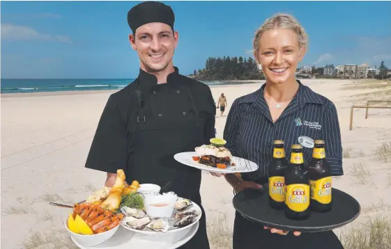  ?? Picture: GLENN HAMPSON ?? Coolangatt­a SLSC’s Mark Thorne and Amelia Nasser are excited about the menu for premium ticket holders at the beach volleyball.