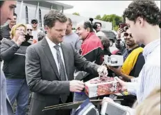  ??  ?? A crowd gathered outside Hendrick Motorsport­s’ shop in Concord, N.C., Tuesday when word got out about Dale Earnhardt Jr.’s announceme­nt.