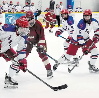  ?? JOHN RENNISON THE HAMILTON SPECTATOR ?? Glanbrook’s Chase Johnston tries to clear the puck as teammates Ryan Burke and Owen Johnston watch in a recent game against the rival Grimsby Peach Kings.