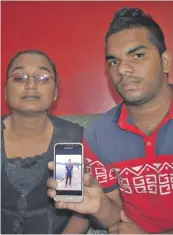  ?? Photo: Nacanieli Tuilevuka ?? Sonal Prasad, right, with a picture of his brother Ravneel, who was one of the three men who died in the road accident.