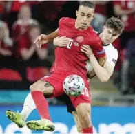  ?? JUSTIN TALLIS/AFP PHOTO ?? GAGAL BERSINAR: Yussuf Poulsen (depan) berduel dengan bek Inggris John Stones pada laga kemarin.