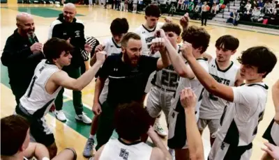  ?? LAURIE SWOPE FOR THE GLOBE ?? A 20-year coaching journey has led Tim St. Laurent (center) to Manchester Essex.