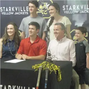  ?? (Photo by Danny P. Smith, SDN) ?? Starkville High School's Carter Bentley, seated middle, and his family celebrate his signing with East Mississipp­i Community College on Wednesday.
