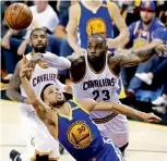  ??  ?? AP In this file picture, Golden State Warriors guard Stephen Curry (30) shoots as LeBron James of Cleveland Cavaliers tries to defend. —