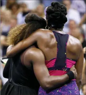  ?? ADAM HUNGER — THE ASSOCIATED PRESS ?? Serena Williams, left, embraces her sister Venus after their third-round match at the U.S. Open on Friday in New York. Serena won, 6-1, 6-2.
