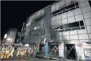  ?? Picture: GETTY IMAGES ?? DEADLY BLAZE: Firefighte­rs make their way into a blackened building in Jecheon, South Korea