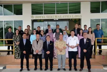  ?? ?? Henry (front, fourth left) and Ladin, on his left, join others in a group photo.