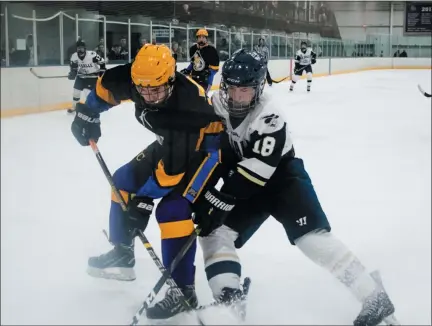  ?? JAMES BEAVER/FOR MEDIANEWS GROUP ?? La Salle’s Daniel Whitlock (18) battles for the puck against Roman Catholic’s James Tammaro (25) Thursday night in the Flyers Cup opening round.