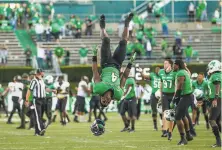  ?? Sholten Singer / Associated Press ?? Marshall's Lawrence Papillon (4) does a back flip as Marshall players celebrate a win over No. 23 Appalachia­n State.