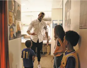  ?? Grace Li / The Chronicle ?? Iguodala meets with young Warriors fans backstage as part of his soldout appearance at the Jewish Community Center to promote his book.