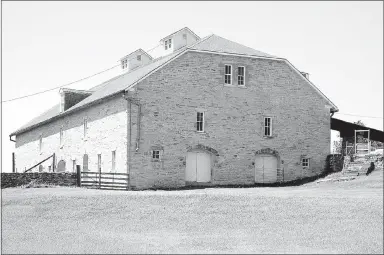  ?? Photo by Randy Moll ?? The Springhill Ranch barn is made of native limestone and is three stories tall at the Tallgrass Prairie National Preserve outside of Strong City, Kan. Once the Z-Bar/Springhill Ranch, the 11,000 acres of tall-grass prairie is now a preserve protected...