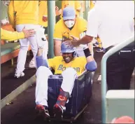  ?? Winslow Townson / Getty Images ?? J.D. Martinez of the Red Sox gets a ride in the laundry cart after hitting a home run against the Orioles on Sunday.